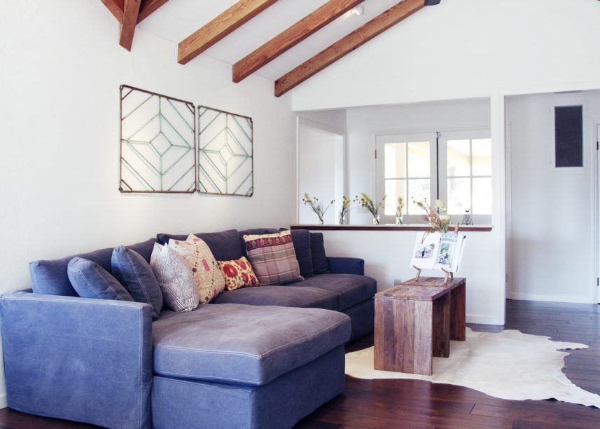 Exposed Beams, Dark Floors, Wooden Coffee Table, Cow Hide Rugs, Pitched Ceiling, Modern Farmhouse